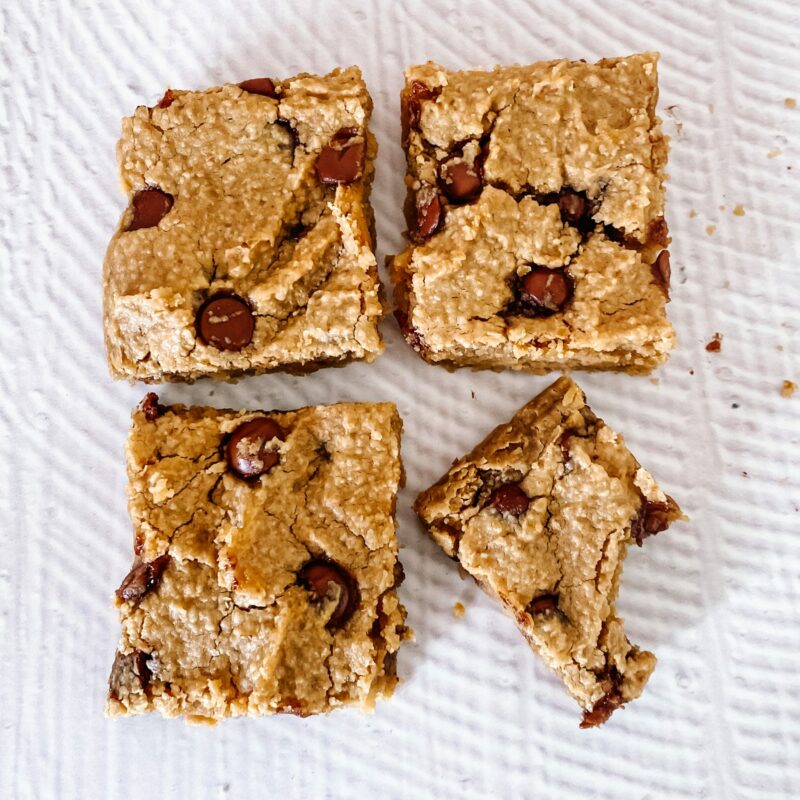 Three slices o0f vegan blondies with the bottom right hand side half eaten