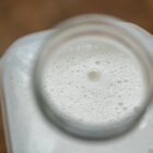 Macro shot of freshly made milk in a clear glass container