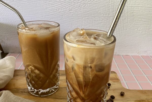 Two glasses of iced coffee with reusable straws.