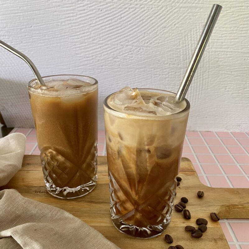 Two glasses of iced coffee with reusable straws.