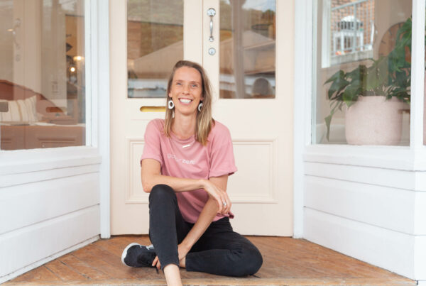 Ellie sitting on the floor smiling