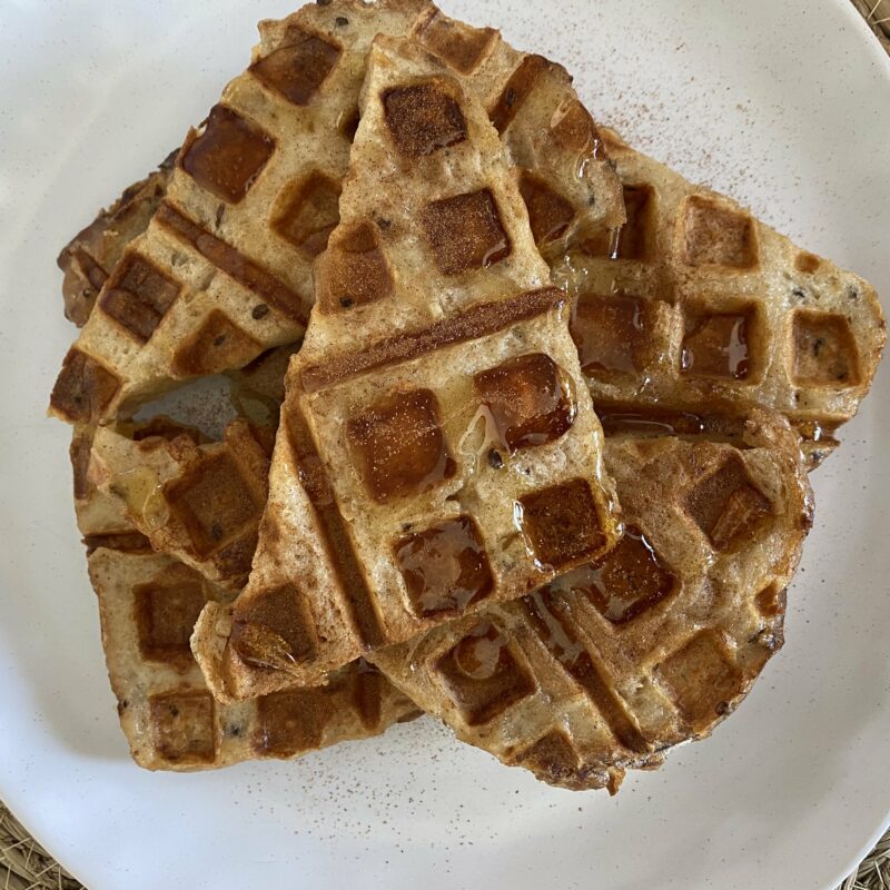 Triangle French Toast slices drizzled with maple syrup on a white plate