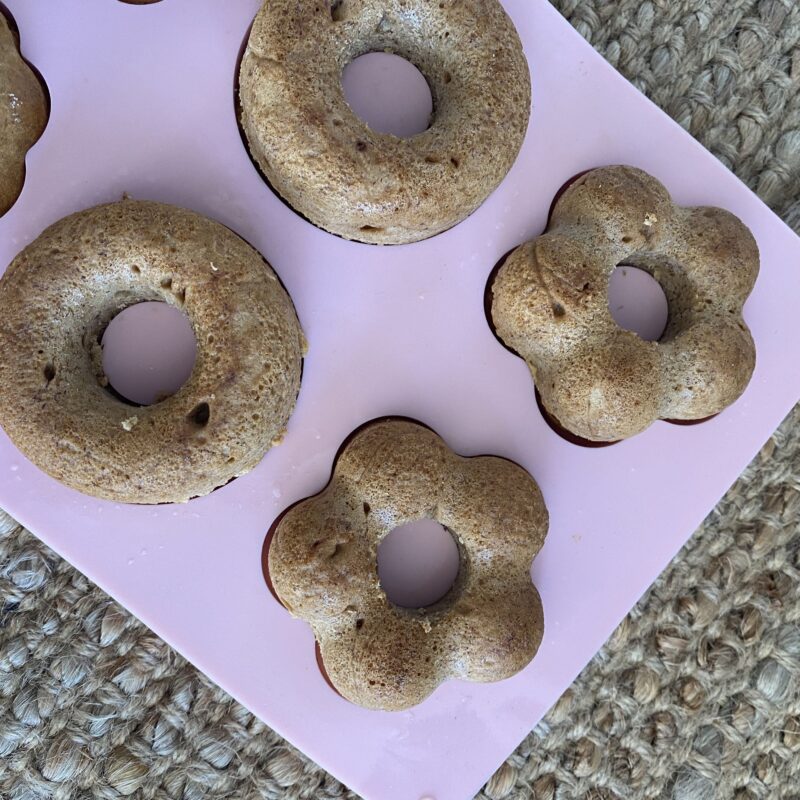 A pink tray of banana bread donuts